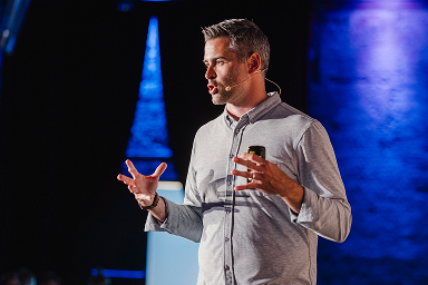 A speaker presenting to a conference audience